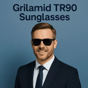 A sharply dressed man in a navy suit and tie wearing black Grilamid TR90 sunglasses stands against a solid blue background, smiling confidently and showcasing the sleek, lightweight frame design.