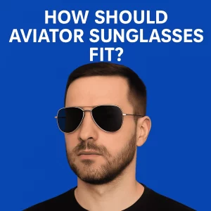 The image shows a close-up shot of a Caucasian person wearing aviator sunglasses, with a clear view of the frame and lenses. The background is blurred, focusing on the person’s face and the sleek, iconic design of the sunglasses. The person is outdoors, highlighting the stylish and practical nature of aviator sunglasses.