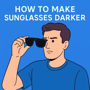 The image shows a 2D digital illustration of a light-skinned man in his 30s, holding a pair of classic black wayfarer sunglasses at eye level with a thoughtful expression. He is dressed in a simple blue crew-neck t-shirt, set against a light blue background. Bold white text at the top reads "HOW TO MAKE SUNGLASSES DARKER." The illustration is in a modern, flat art style with clean lines.