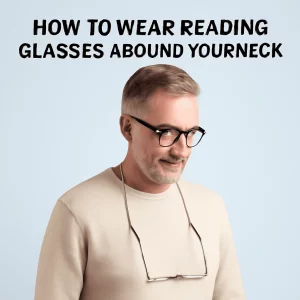 A middle-aged man with short gray hair, wearing a beige sweater and glasses, demonstrates how to wear reading glasses on a silver chain around his neck. The text 'HOW TO WEAR READING GLASSES AROUND YOUR NECK' is prominently displayed above him in bold black letters against a light blue background.
