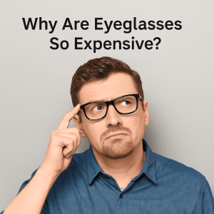 A thoughtful-looking Caucasian man in his mid-30s wearing black eyeglasses and a blue shirt, touching his temple with one finger while gazing upward. Above him is the question, “Why Are Eyeglasses So Expensive?” written in bold black text on a neutral background.